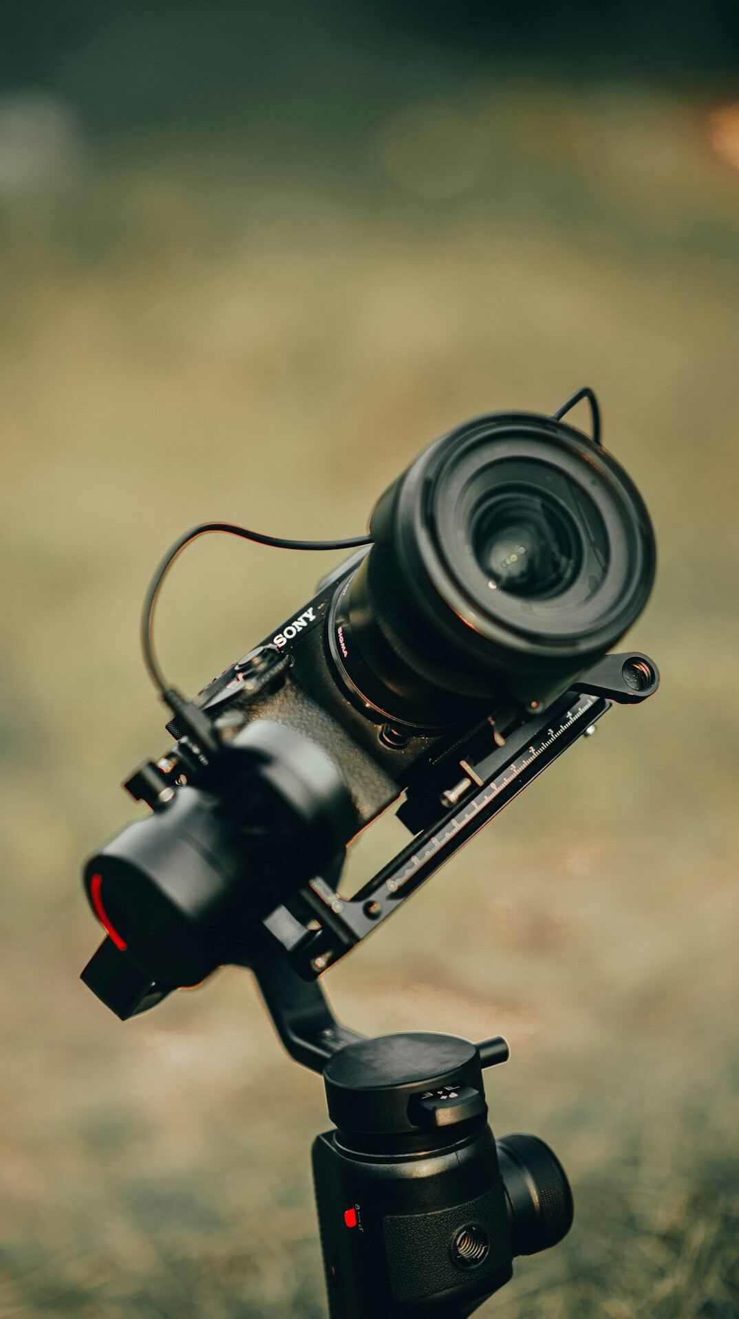 Close-up of a professional video camera with lens on a tripod