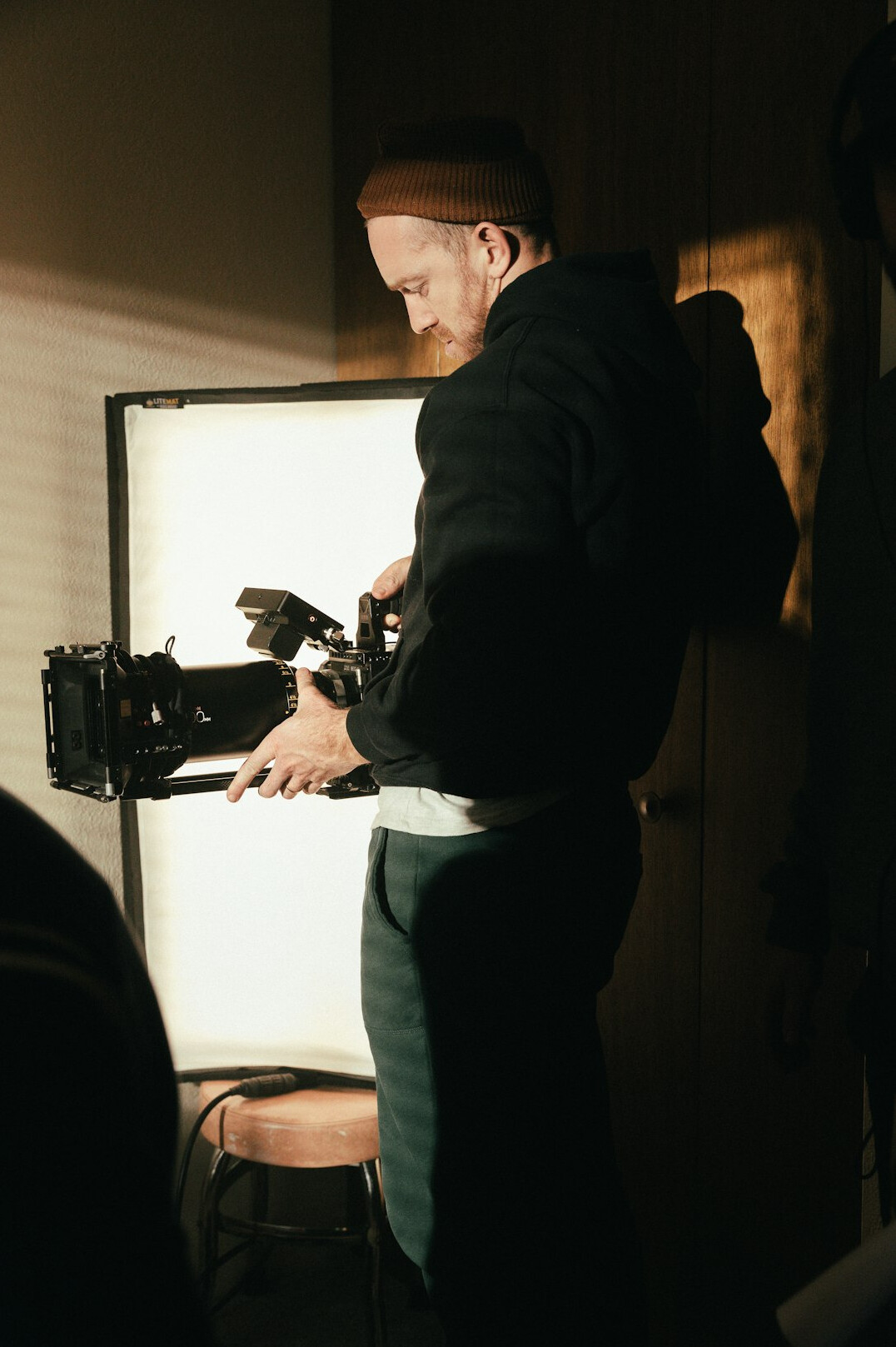 cinematographer setting up lights on film set