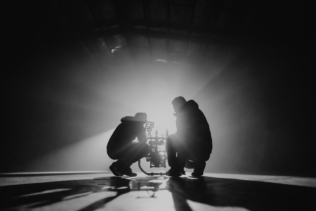 cinematographer lighting a film set